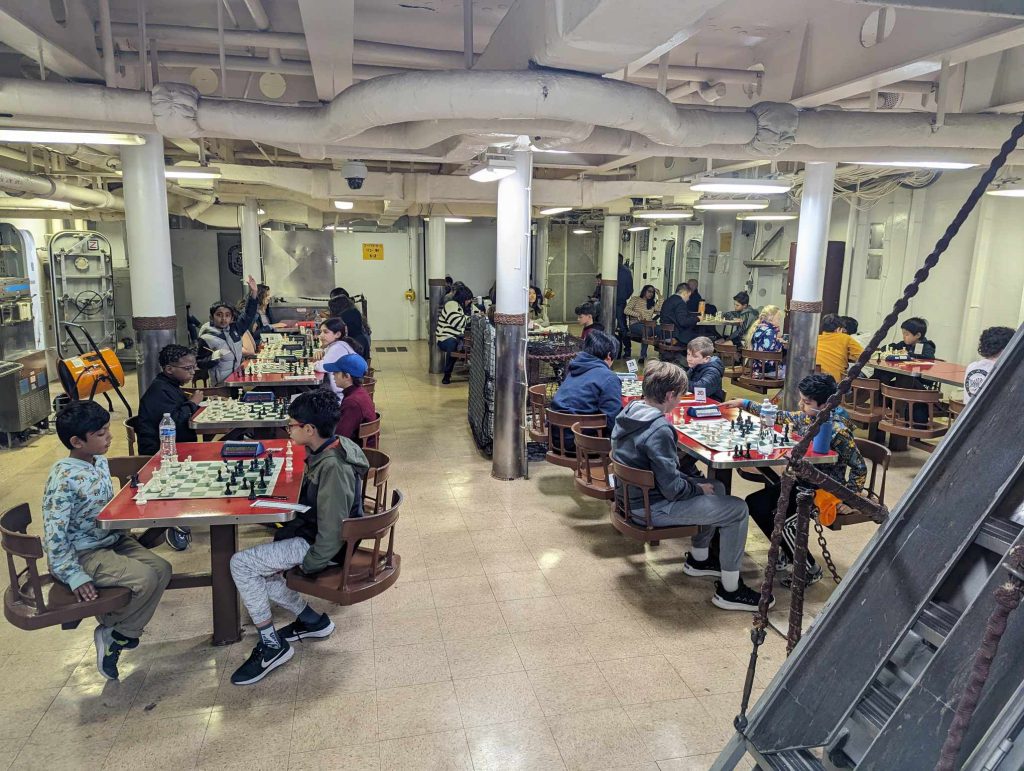 Scholastic chess players participating in a tournament in the mess hall of the Battleship Wisconsin